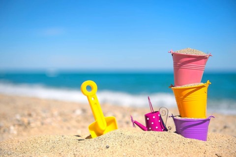 Colorful toy buckets at the beach