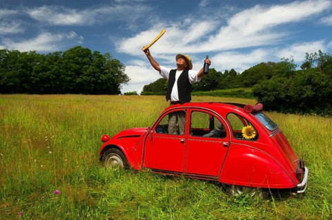 Typical French man with bread wine and his car