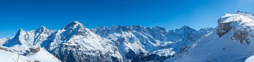 Various alpine peaks including Eiger, Moench, and Jungfrau, seen from the skiing resort Schilthorn
