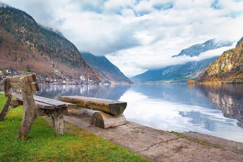 Travel destinations theme image with the Dachstein Mountains reflected in the water of the