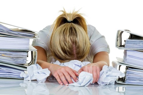 Young woman in the office is overwhelmed with work. burnout syndrome at work or study. Austria