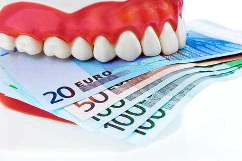 A dental model at the dentist with euro notes. Costs for health. Austria