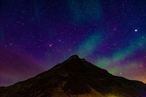 Of Iceland Aurora and mountain silhouette. Shooting Location: Iceland, Reykjavik