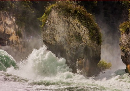 Wild water rages around the rocky island in the Rhine Falls near Schaffhausen