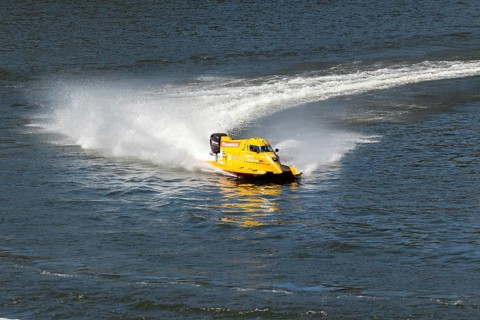 PESO DA REGUA, PORTUGAL - SEPTEMBER 15, 2024: Yellow Powerboat Makes Sharp Turn with Splashes of