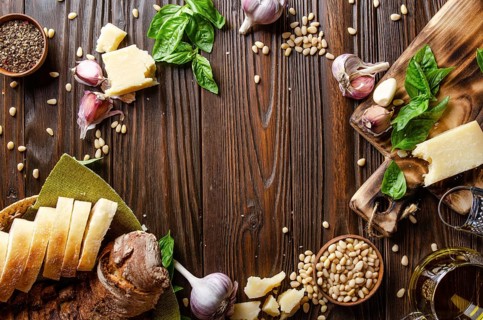 Flat lay view at food background of genovese pesto sauce ingredients on wooden kitchen table with