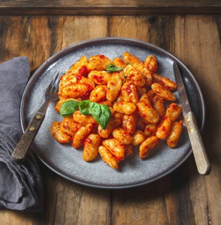 Food, Traditional Italian potato Gnocchi with tomato sauce and fresh basil on blue plate on wooden