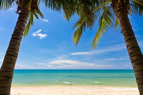 Sand beach with palms and canoes in Phu Quoc close to Duong Dong, Vietnam, Asia