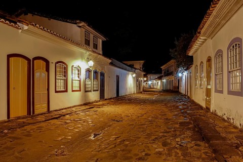 Atmospheric night view of illuminated street and buildings in historical center of Paraty, Brazil,