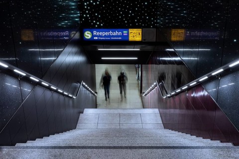 Entrance to the Reeperbahn underground station while two people walk down the stairs, St. Pauli,