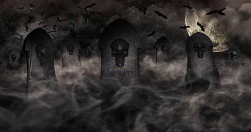Cemetery At Night With Tombstones With Skulls And Cloudy Sky Full Of Stars in The Background.