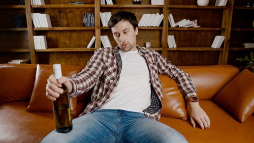 Alcohol addiction at young age. Caucasian male cannot stop drinking alcohol, drunken lonely male