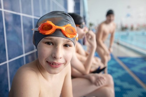 Belarus, the city of Gomel, 10 March 2021. School swimming pool. A boy with a swimming cap looks