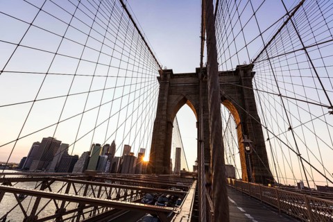 Brooklyn Bridge sunset with Manhattan skyline of New York City USA