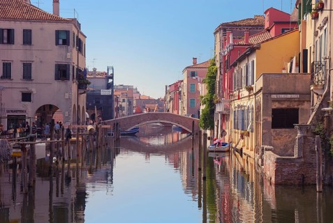 Bridge over canal in Chioggia, Italy. Typical Italian houses and gondolas, Chioggia, Italy, Europe