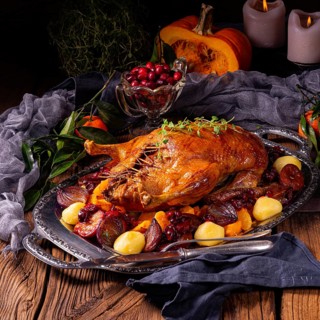 Roast duck with potato dumplings and plums