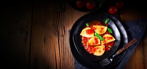 Ravioli alla genovese with basil and tomato sauce