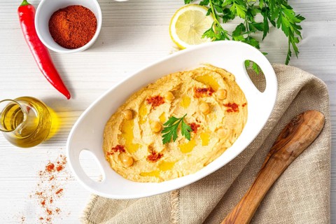 Hummus paste with lemon and chilli on a white background