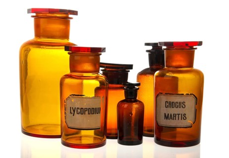 Glass bottles as pharmacy equipment isolated over white background