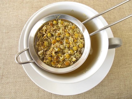Camomile tea in a tea strainer