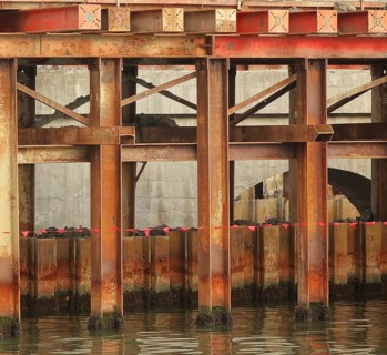 Bridge construction detail with massive steel girders anchored in the ground