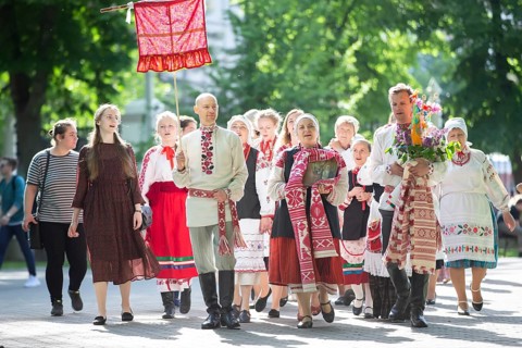 People in Belarusian national costumes perform a national ethnic ritual