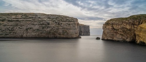 A panorama landscape view of Dwejra Bay and Ufo Rock on Gozo Island in Malta