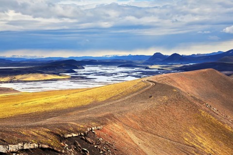 National park Landmannaleygar in July. Comb orange rhyolite mountains dashed off tourist jeeps