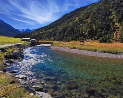 Austrian Alps. Starting famous Krimml waterfalls. Crystal clear water sparkles in the midday sun.