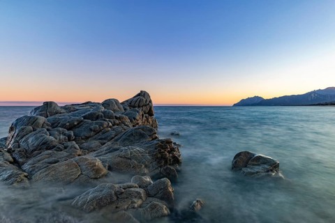 Rocks in the sea on the beach of Torre di Bari at sunset, long exposure, Torre di Bari, Bari Sardo,