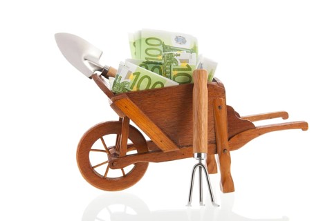 Gardening with euros in wheelbarrow isolated over white background