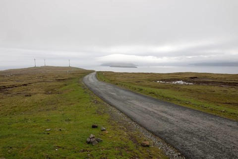 Street on the Faroe Islands in the south of Eysturoy with wind mills and nolsoy, Æduvik, Faroe