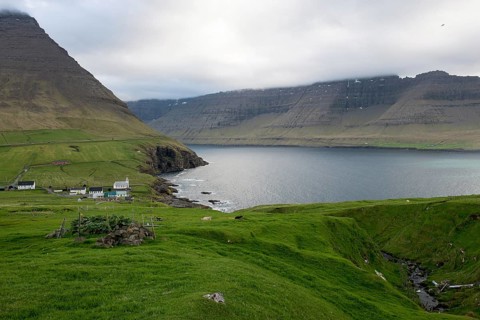 Typical landscape on the Faroe Islands, with green grass and rocks and Vidareidi, Vidareidi, Faroe