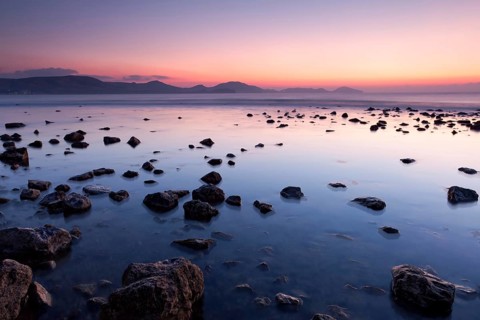 Colorful sunrise on the rocky sea coast