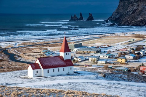 Icelandic village of Vik, Southeast Iceland with the VIk i Myrdal church at the top of the hill