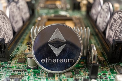 Ethereum coin close-up on a computer circuit motherboard as a blockchain technology payment network