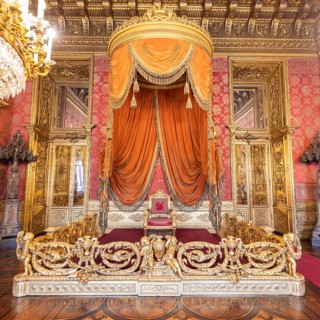 Turin, Italy, Circa August 2021: old throne room interior with chair in luxury palace. Red and gold