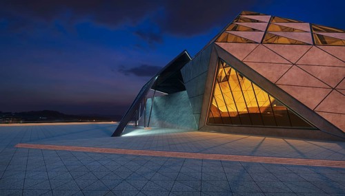 Contemporary triangle shape design modern Architecture building exterior with glass, concrete and