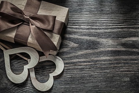 Present box white wooden hearts on vintage wood board celebrations concept