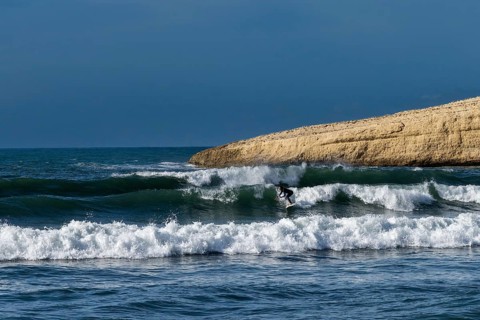 Santa Caterina di Pittinuri, Italy, 13 December, 2022: surfer enjoying good waves on the west coast