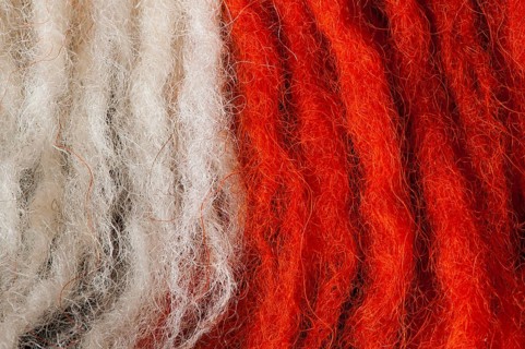 White and red wool fibers closeup