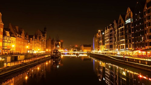 Old town in Gdansk at night. The riverside on Granary Island reflection in Moltawa River Cityscape