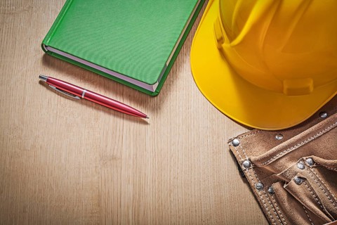 Collection of construction equipment on wood board