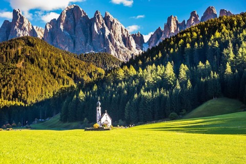 Dolomites, Tirol. Sunny autumn day. The famous symbol of the valley Val di Funes - church of Santa