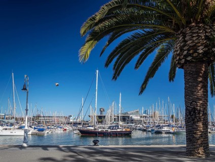 Urban marina view and pedestrian promenade in port vell area of barcelona spain