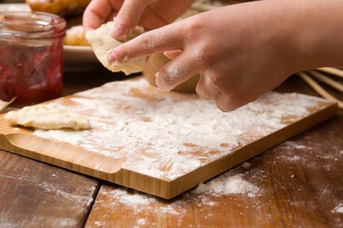 Detail of hands kneading dough, lodz, poland
