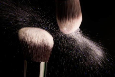 Cosmetics brush and colorful makeup powder