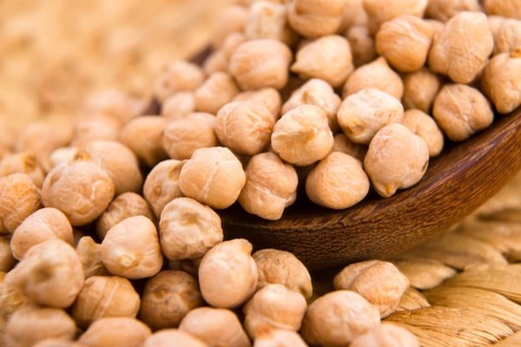 Dried white chickpeas ceci on the wooden spoon, lodz, poland