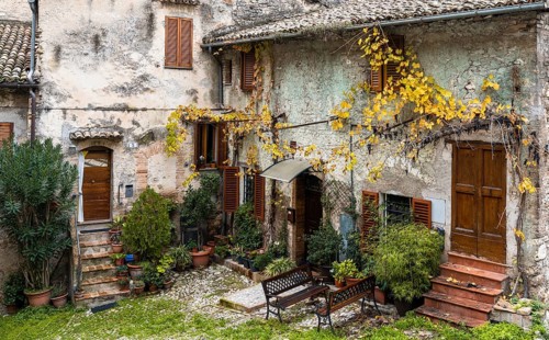 Spoleto, Italy, 25 November, 2022: rustic stone house and small backyard in the historic city