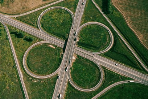 Clover or daisy type of road junction. Aerial top down view of beautiful highway road junction in